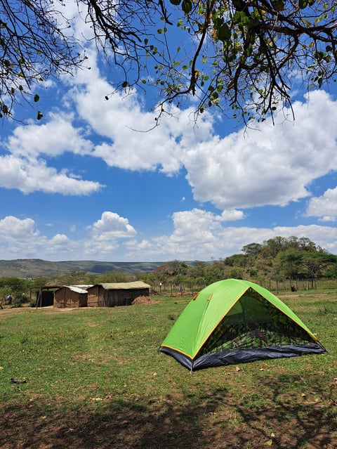 A tent set up in a traditional rural homestead