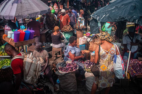 Overall view of the vendors, customers, passers-by of goods, men and women who populate the Ndokoti market in Douala on the coast of Cameroon