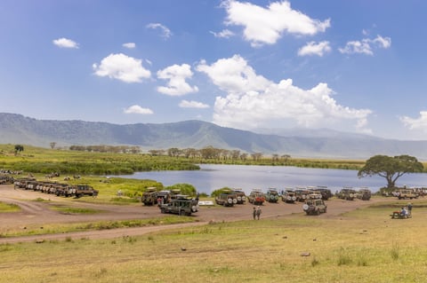 Ngorongoro crater, Tanzania - Safari jeep driving across the open plains of Ngorongoro Crater