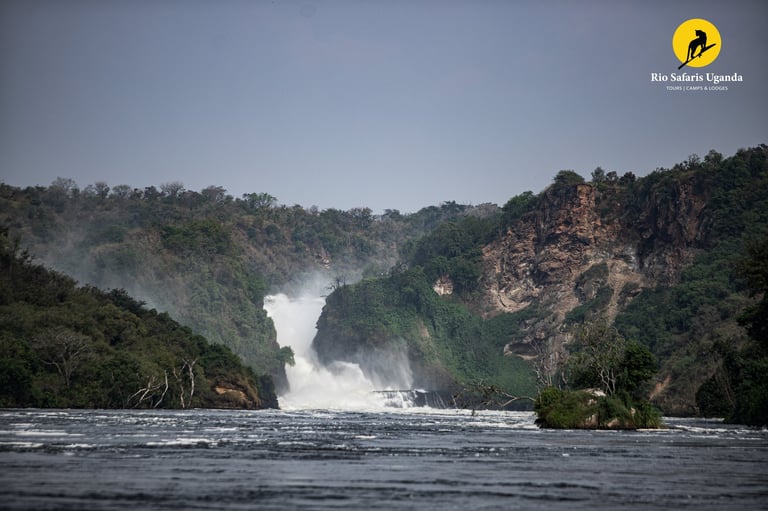 Murchison Falls waterfall cascading from forested cliffs into the Nile River in Uganda